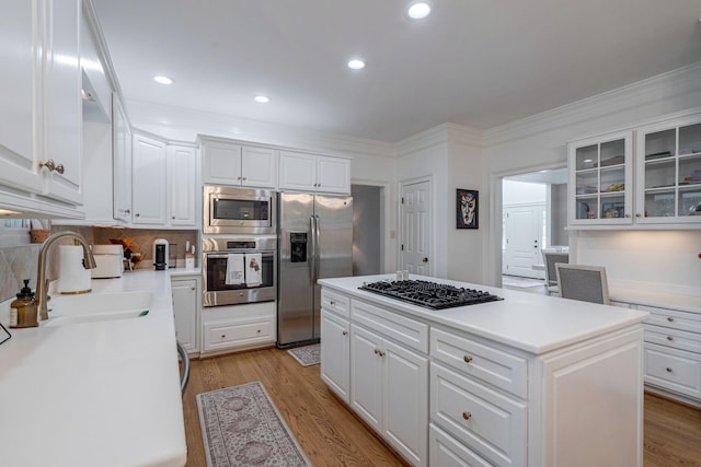 3665 Bay Point Ct, Martinez, GA 30907 - kitchen featuring stainless steel appliances, a center island, glass insert cabinets, white cabinets, and ornamental molding