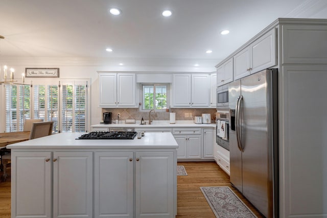 3665 Bay Point Ct, Martinez, GA 30907 - kitchen featuring appliances with stainless steel finishes, a center island, light countertops, crown molding, and recessed lighting