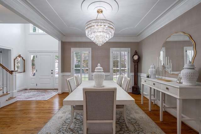 3665 Bay Point Ct, Martinez, GA 30907 - dining area with stairs, wood finished floors, a chandelier, ornamental molding, and a decorative wall