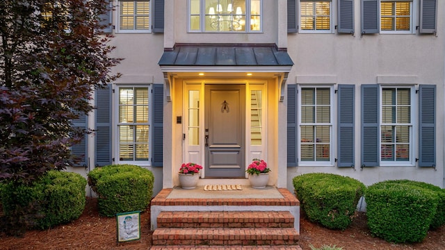 3665 Bay Point Ct, Martinez, GA 30907 - view of exterior entry with stucco siding, a standing seam roof, and a metal roof