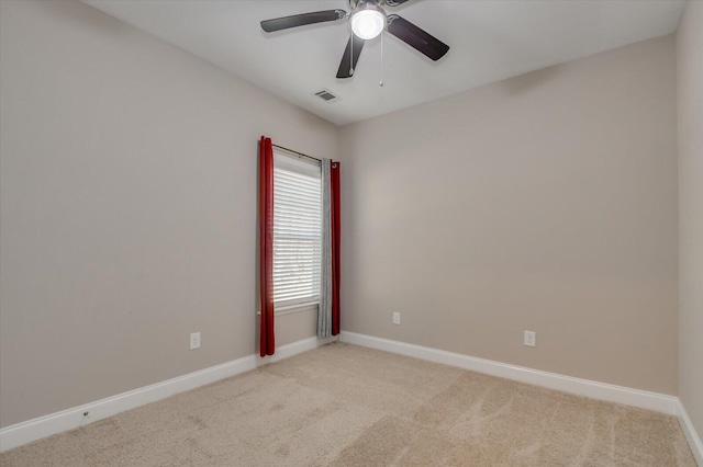 empty room with light carpet, baseboards, visible vents, and ceiling fan