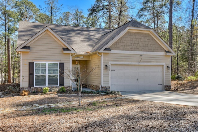 craftsman-style home with driveway, stone siding, roof with shingles, and an attached garage