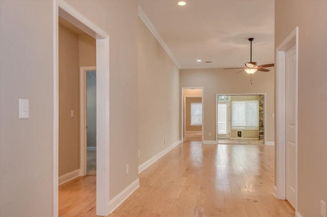 interior space featuring ornamental molding, recessed lighting, light wood-style flooring, and baseboards