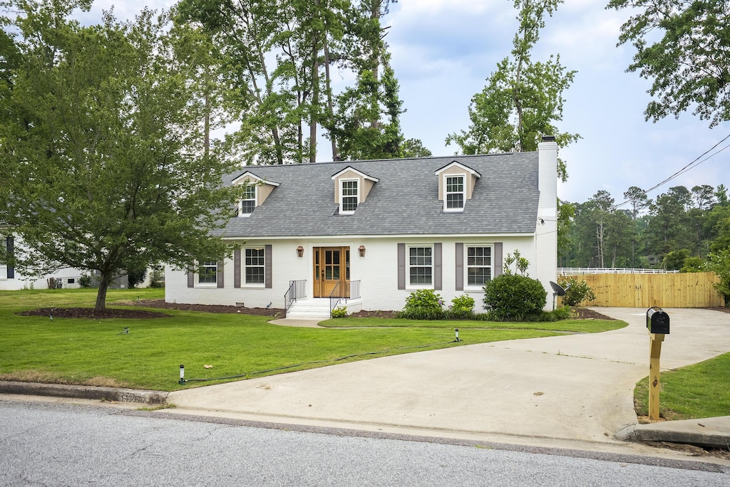 3520 Jamaica Dr, Augusta, GA 30909 - cape cod home featuring a chimney, driveway, and roof with shingles