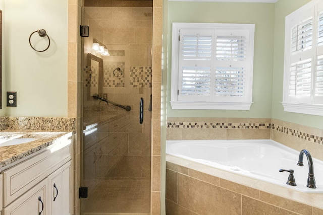 bathroom with vanity and separate shower and tub