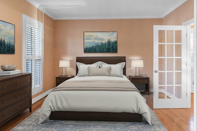 bedroom featuring wood-type flooring and ornamental molding