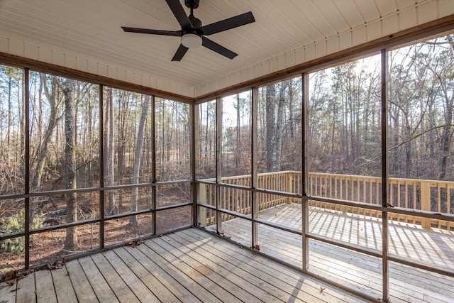 unfurnished sunroom with ceiling fan