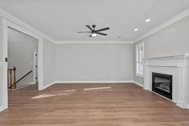 unfurnished living room featuring light hardwood / wood-style floors, ceiling fan, and ornamental molding