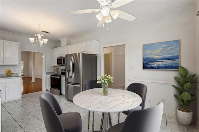dining area with ornamental molding, a ceiling fan, and a chandelier