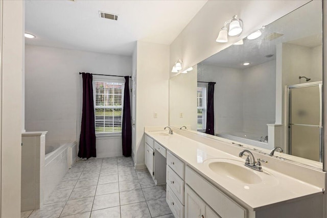 bathroom featuring a garden tub, double vanity, a stall shower, and baseboards