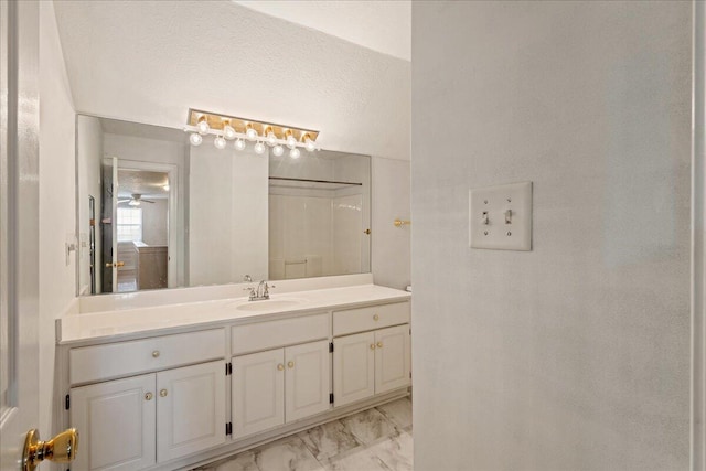 bathroom featuring marble look tile flooring, vanity, and ceiling fan