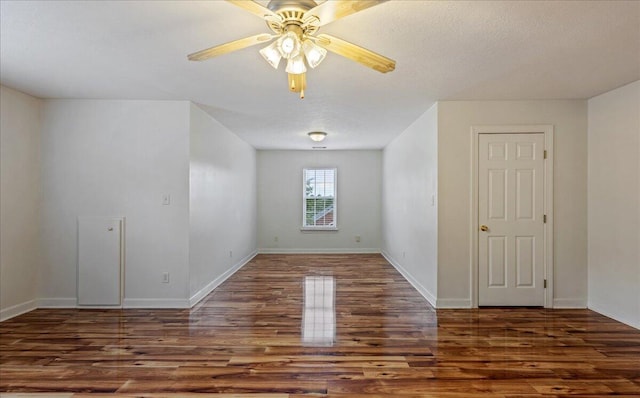unfurnished room featuring wood finished floors, a ceiling fan, baseboards, and a textured ceiling