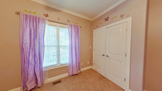 unfurnished bedroom with carpet floors and crown molding