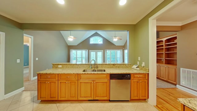 kitchen featuring stainless steel dishwasher, hanging light fixtures, sink, light tile patterned floors, and light stone counters