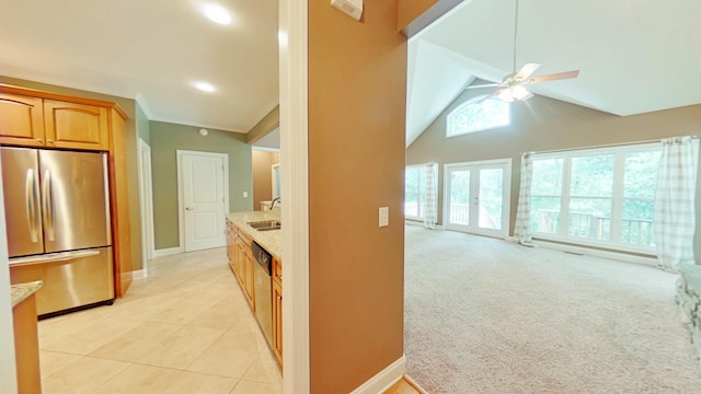 kitchen with light carpet, ceiling fan, french doors, sink, and appliances with stainless steel finishes