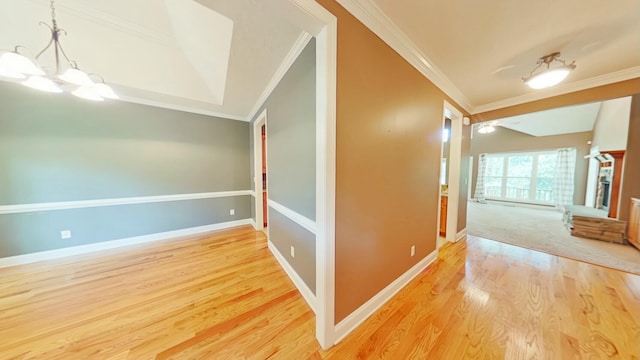 hallway featuring hardwood / wood-style floors, a notable chandelier, and ornamental molding