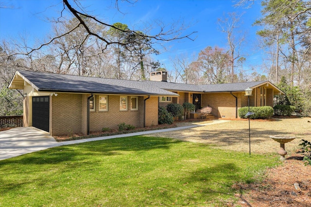 view of front facade featuring concrete driveway, a front yard, an attached garage, brick siding, and a chimney