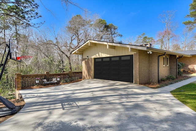 view of property exterior with brick siding, concrete driveway, and an attached garage