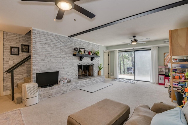 living area with visible vents, brick wall, carpet floors, a fireplace, and ceiling fan