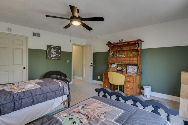 carpeted bedroom with visible vents, baseboards, and ceiling fan