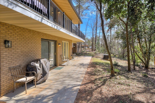 exterior space featuring central air condition unit, a balcony, and grilling area