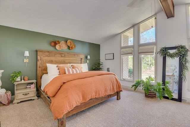 carpeted bedroom featuring baseboards and vaulted ceiling with beams