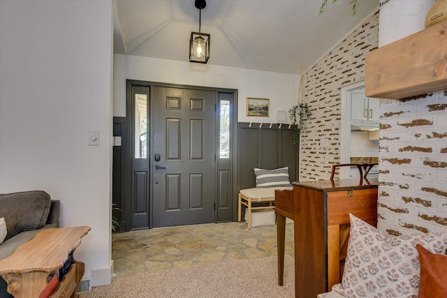 foyer featuring vaulted ceiling