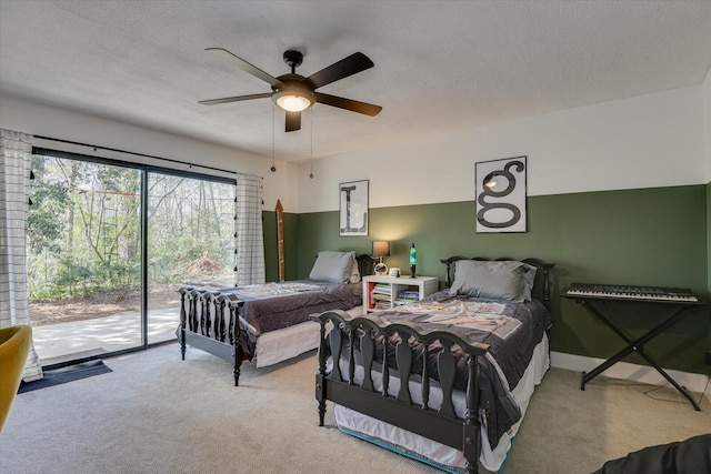 bedroom featuring carpet, baseboards, ceiling fan, a textured ceiling, and access to outside