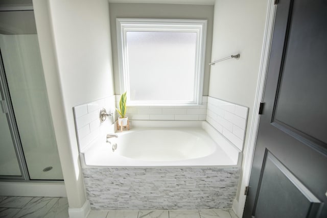full bath featuring a stall shower, marble finish floor, and a garden tub