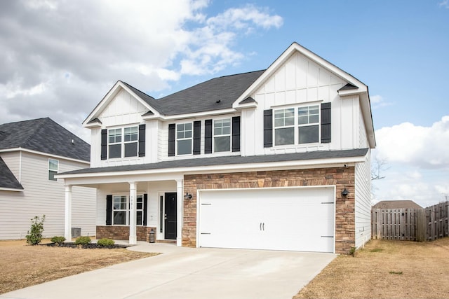 view of front of home with board and batten siding, fence, an attached garage, and a porch