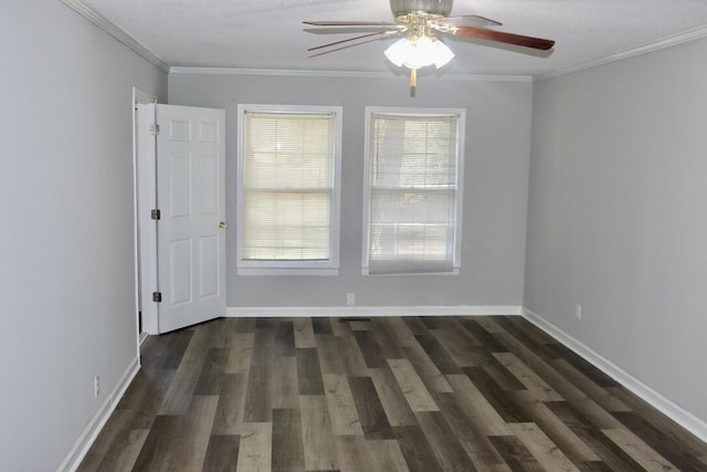 spare room featuring crown molding, baseboards, dark wood-type flooring, and ceiling fan