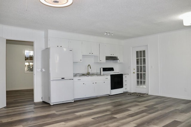 kitchen with electric range, freestanding refrigerator, light countertops, white cabinets, and under cabinet range hood