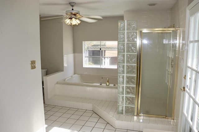 bathroom featuring ceiling fan, plenty of natural light, and a stall shower