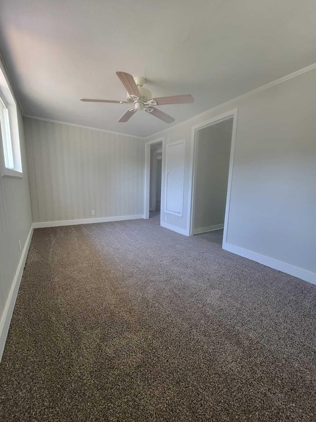 carpeted empty room with ceiling fan and ornamental molding