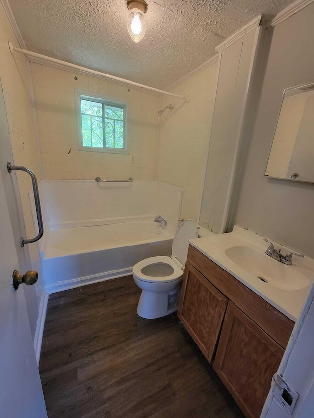 full bathroom featuring hardwood / wood-style floors, shower / bath combination, a textured ceiling, toilet, and vanity