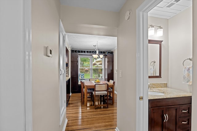 492 Pheasant Run Dr, Evans, GA 30809 - hallway with light wood-type flooring, a sink, and baseboards