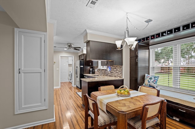 492 Pheasant Run Dr, Evans, GA 30809 - dining room featuring a chandelier, baseboards, a textured ceiling, light wood-style flooring, and ceiling fan