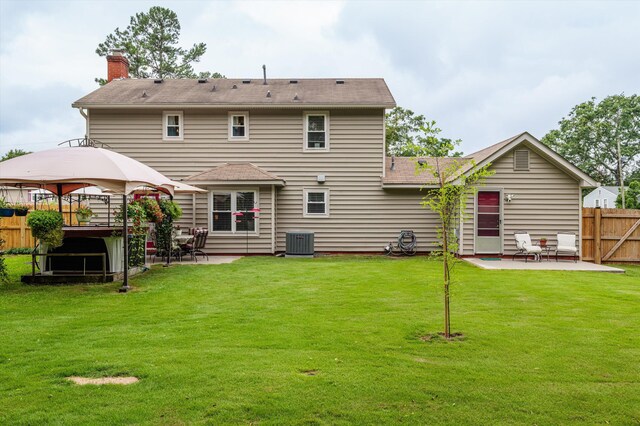 492 Pheasant Run Dr, Evans, GA 30809 - back of property with a patio, a gazebo, central AC unit, a chimney, and a jacuzzi