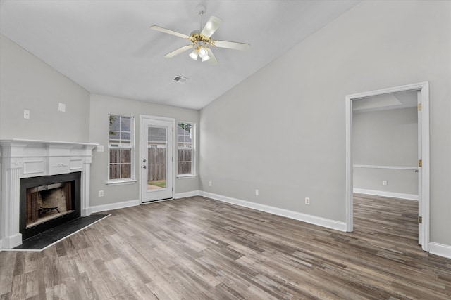 55 Charlestowne Dr, Augusta, GA 30907 - unfurnished living room with wood finished floors, a fireplace with raised hearth, a ceiling fan, and high vaulted ceiling
