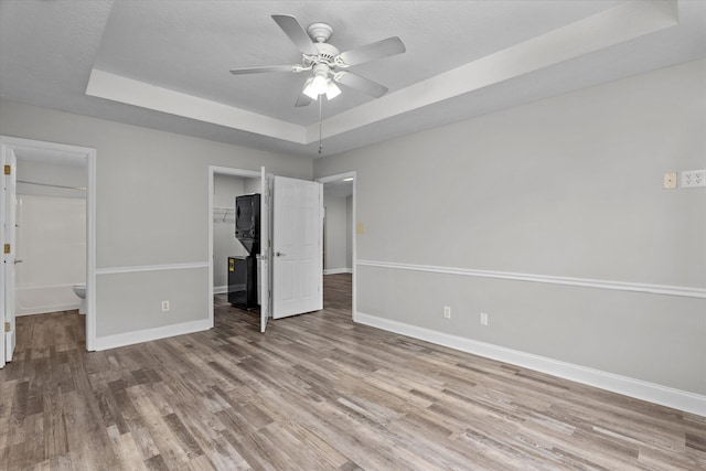 55 Charlestowne Dr, Augusta, GA 30907 - unfurnished bedroom featuring a raised ceiling, wood finished floors, a walk in closet, a closet, and a ceiling fan