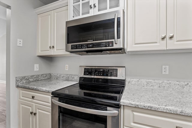 55 Charlestowne Dr, Augusta, GA 30907 - kitchen with appliances with stainless steel finishes, white cabinetry, and glass insert cabinets