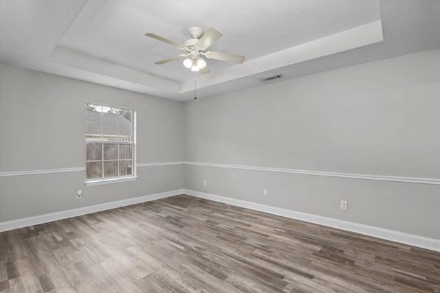 55 Charlestowne Dr, Augusta, GA 30907 - spare room featuring a tray ceiling, wood finished floors, and a ceiling fan