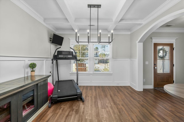 workout area featuring arched walkways, coffered ceiling, wood finished floors, and a decorative wall