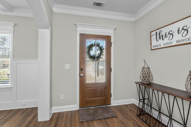 entrance foyer with visible vents, crown molding, baseboards, and wood finished floors