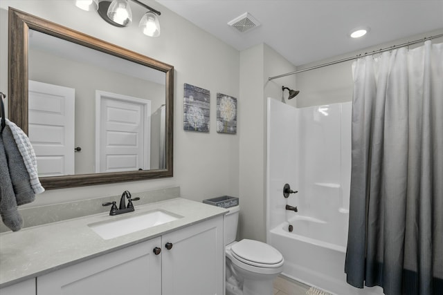 bathroom featuring toilet, visible vents, shower / bath combo with shower curtain, and vanity