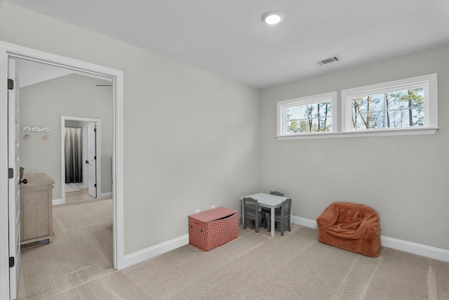 living area featuring carpet floors, visible vents, and baseboards