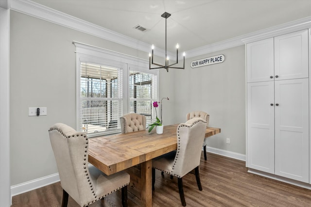 dining space with ornamental molding, dark wood-style flooring, visible vents, and an inviting chandelier