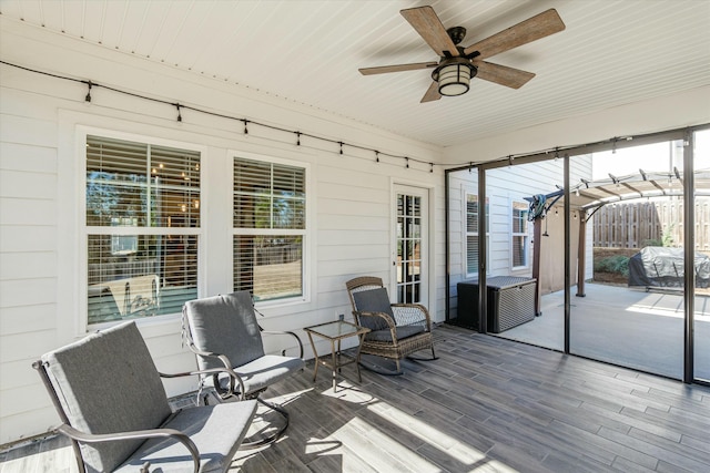 sunroom featuring a ceiling fan