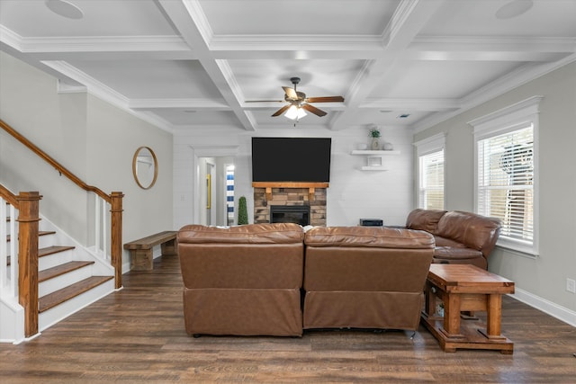 living area featuring dark wood finished floors, a fireplace, stairway, coffered ceiling, and beamed ceiling