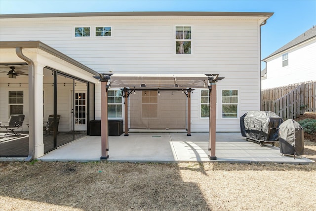 back of house with fence, a pergola, and a patio